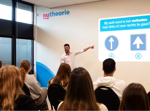 Course leader teaching a theory class to a group of students